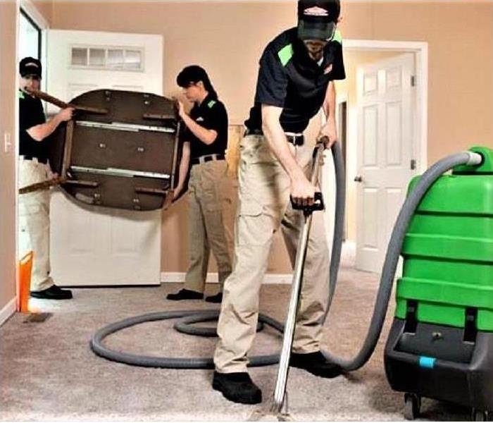 Servpro crew cleaning carpets.